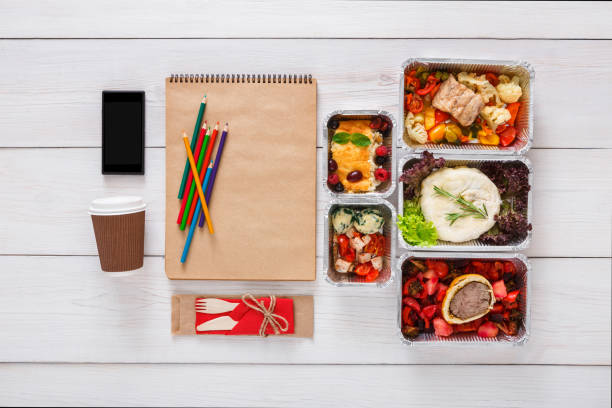 istock Healthy food, lunch in foil box on student table, diet 866111858