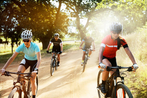 istock Determined cyclists riding bicycles on dirt road 866120324