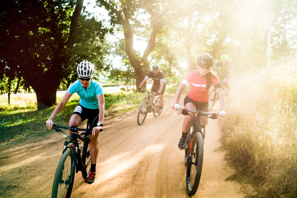istock Cyclists riding bicycles on dirt road 866121736