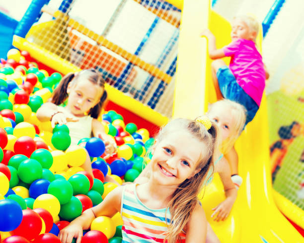 istock Girl playing with multicolored plastic balls 866123460