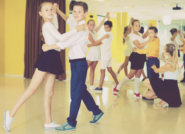 istock Little boys and girls having dancing class in classroom 866123612