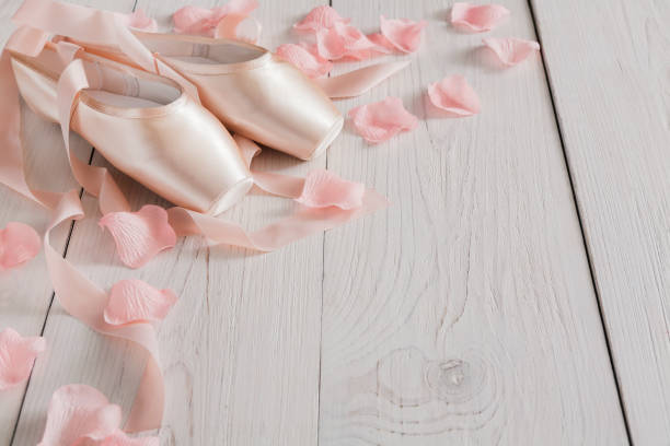 istock Pink ballet pointe shoes on white wood background 866124466