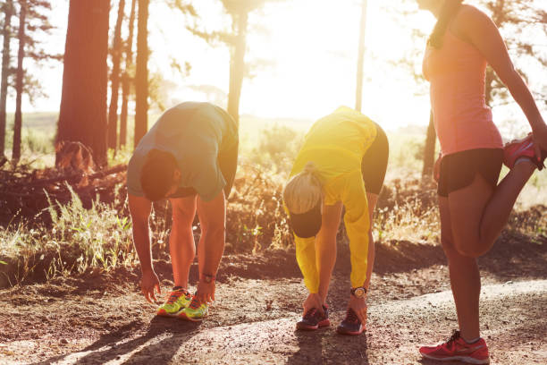 istock Friends warming up on dirt road before exercise 866127526