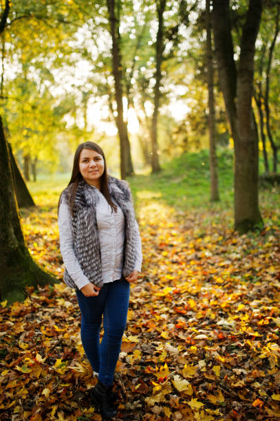 istock Brunette girl on majestic autumn fall forest. 866130914