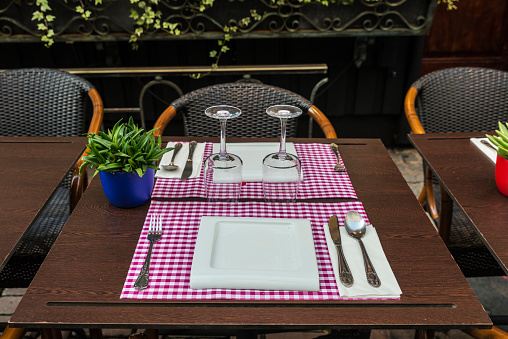 Table ready to sit down to eat with glasses, plates and cutlery on a street in Brussels, Belgium