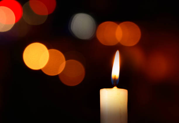 single lit candle with quite flame - brightly lit imagens e fotografias de stock