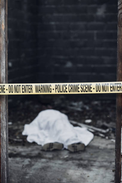 Dead body in a room that is covered by a cordon tape The dead body is seen lying on the floor in a room that is covered by a cordon tape. people covered in mud stock pictures, royalty-free photos & images