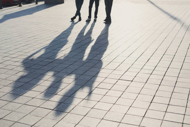 istock Shadows of three friends on pavement 866133140
