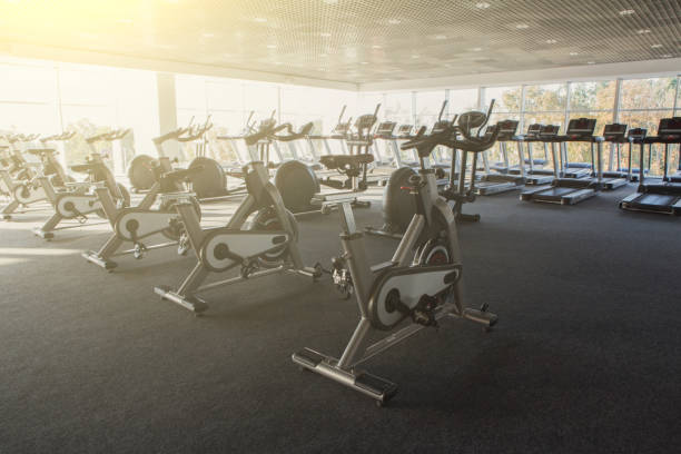 istock Modern gym interior with equipment, fitness exercise bikes 866139282