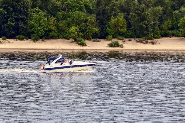 istock White yacht sails along the river along the shore 866142762