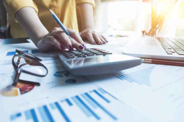 istock A woman working with calculator and laptop computer for business financial document report, business finance concept 866149740