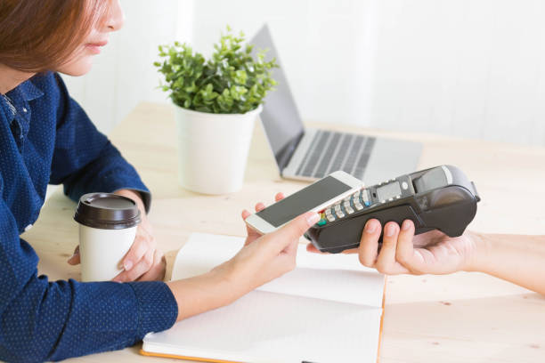 istock woman making a contactless smartphone payment. 866150714