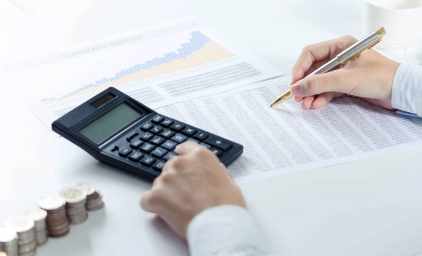 istock Woman using calculator with doing finance at home office. 866150716