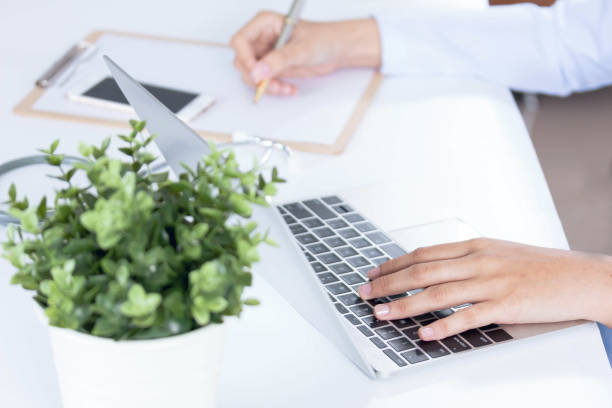 istock Doctor typing on his computer in the office 866150738