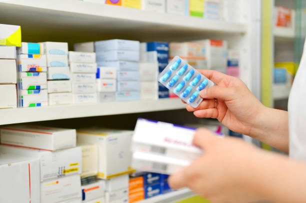 istock Pharmacist holding medicine box and capsule pack 866153456