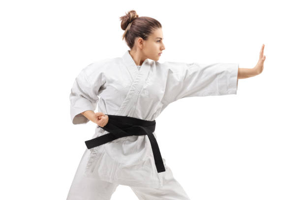 istock Young woman in a kimono practicing karate 866154084