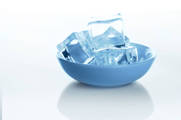 istock Transparent ice cubes bowl on white background with water drops 866154654