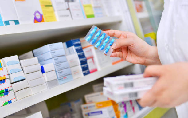 istock Pharmacist holding medicine box and capsule pack 866158412