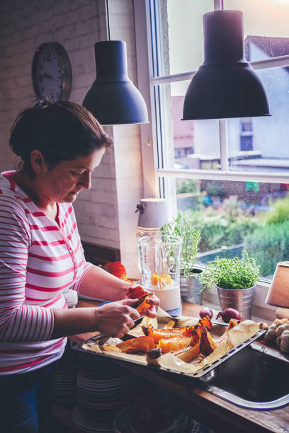 istock Cutting Fresh Pumpkins for Roasting in the Oven 866159370