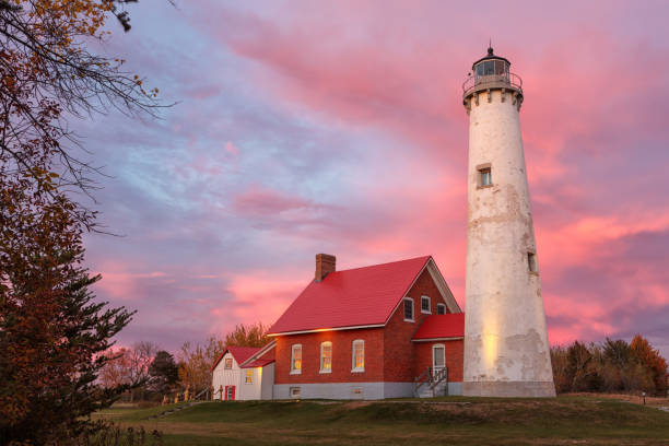 Tawas Point Lighthouse at Sunset in Tawas Michigan stock photo