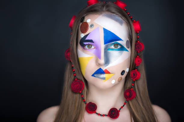 Creative make-up new conceptual idea. blue red black white bold body art painting. Crazy new graphic abstract picture on woman face surrealistic. Horizontal professional photo. Circle accessory design