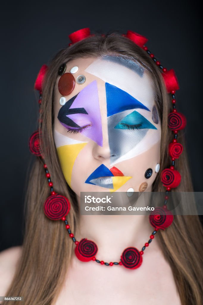 woman beauty face Creative make-up, new conceptual idea. blue red black white bold body art painting. Crazy new graphic abstract picture on woman face surrealistic. Vertical professional photo. Circle accessory design Above Stock Photo