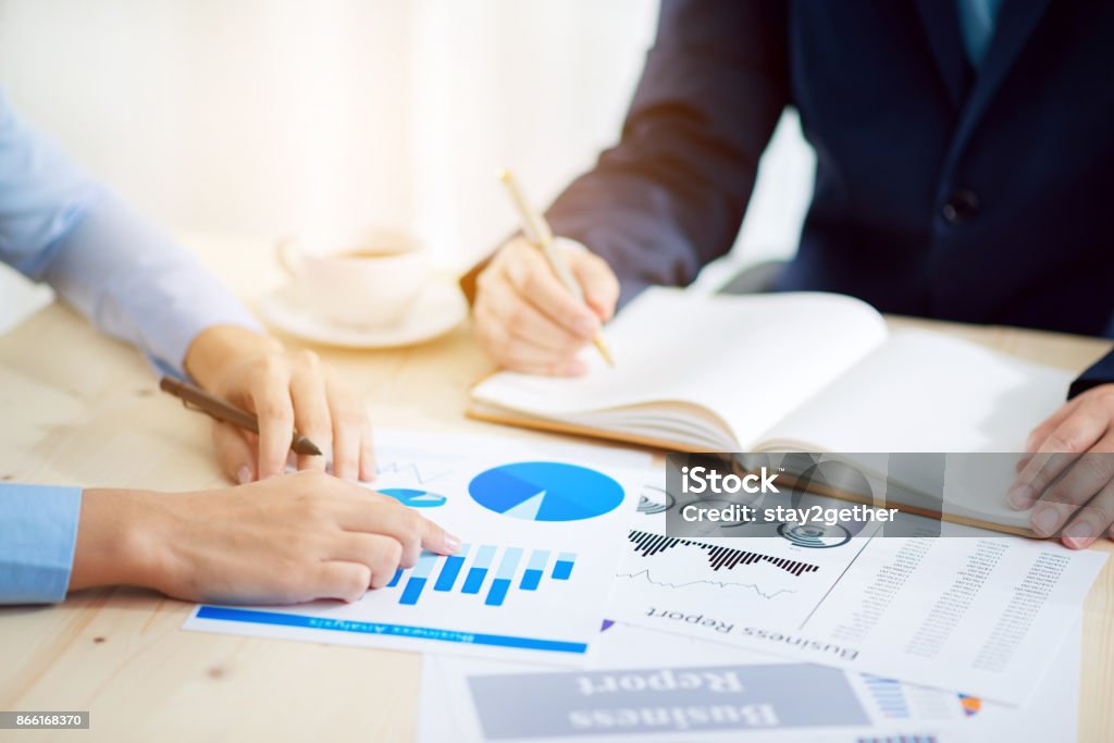 Business meeting time. Idea presentation, analyze plans.business concept. Business meeting time. Photo young account managers crew working with new startup project. Notebook on wood table. Idea presentation, analyze plans.business concept. Adult Stock Photo