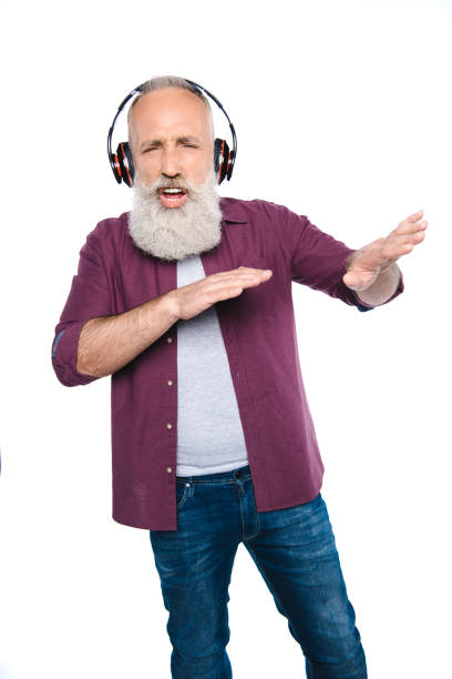 istock senior man dancing and singing with headphones 866168706
