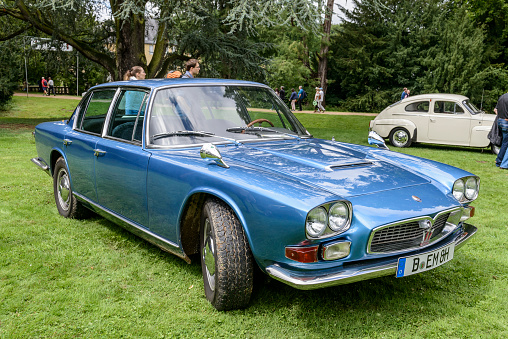 1960s Maserati Quattroporte luxury Italian saloon car. The car is on display during the 2017 Classic Days event at Schloss Dyck. People in the background are looking at the cars.