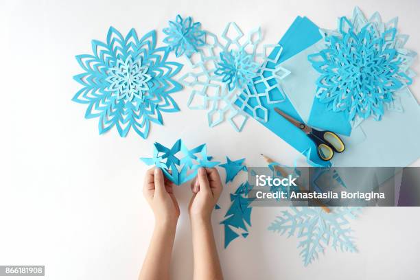 Making Of Snowflakes From Blue Paper Stock Photo - Download Image Now - Craft, Winter, Child