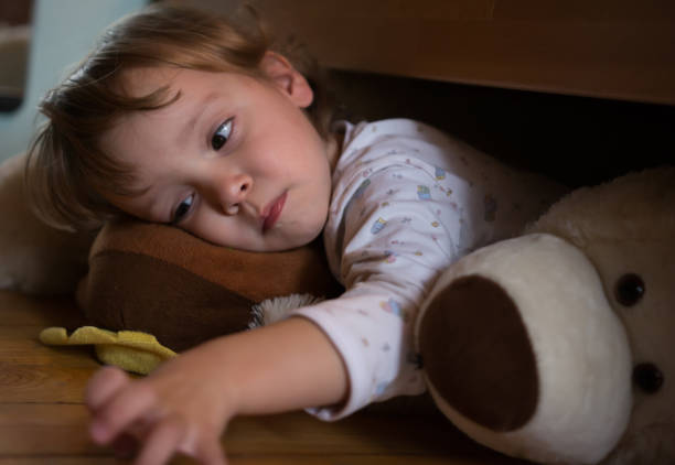 istock Sad Little Girl Holding Her Teddy Bear 866183018