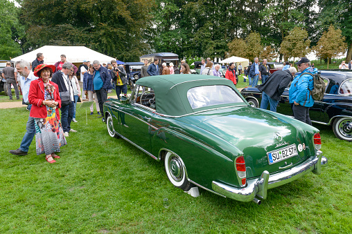Mercedes-Benz 220S Convertible (W180) classic convertible car. The 220 Convertible was built from 1956 until 1959. The car is on display during the 2017 Classic Days event at Schloss Dyck. People in the background are looking at the cars.