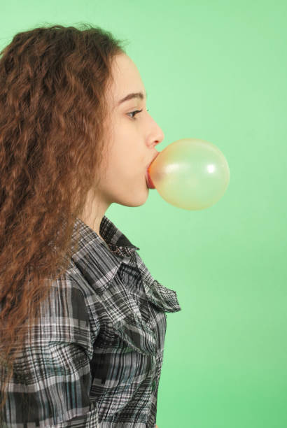 istock Girl blowing a bubblegum bubble 866186170