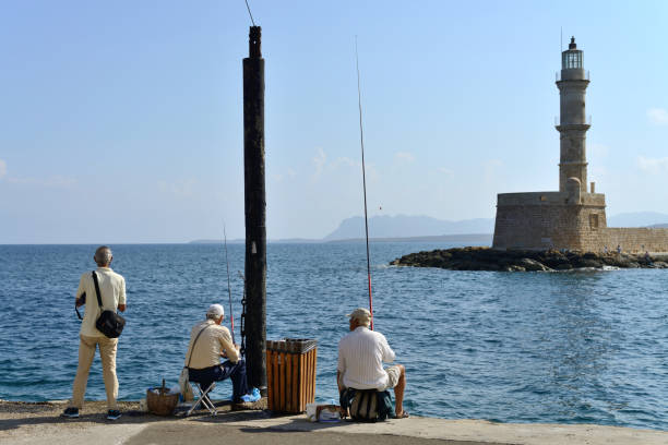 Crete, Greece - August 07: Unknown people fishing in Chania, Greece on August 07, 2014. Chania is one of the most popular tourist place on Crete island in Greece.