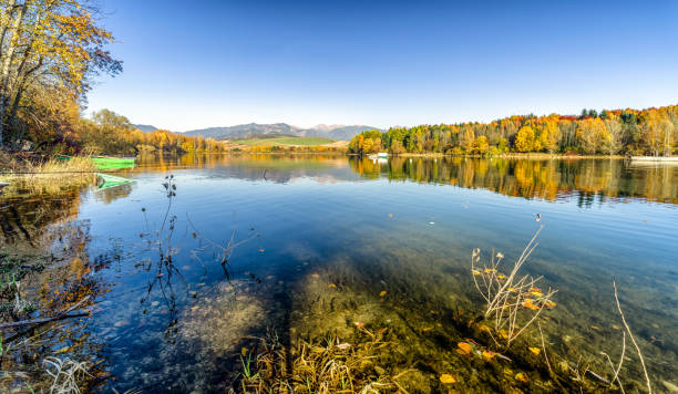 istock Reflection of autumn trees on lake 866186696