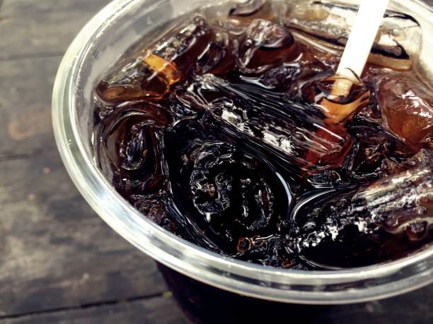 Cola Dark and sweet drink in a glass with ice.