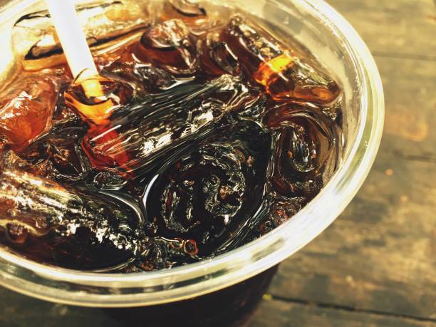 Cola Dark and sweet drink in a glass with ice.