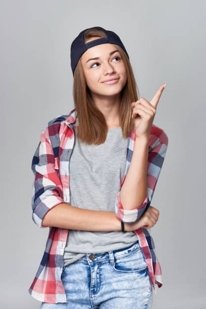 istock Teen girl pointing at empty copy space 866187334