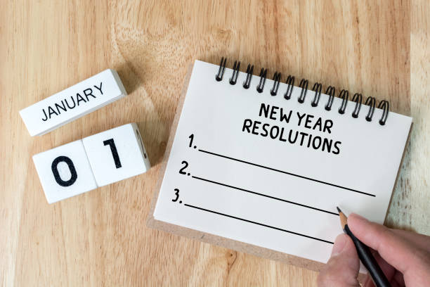 istock Top view notebook and calendar on wood table, New year resolution concept 866191616