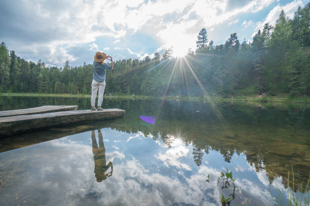 istock Young woman making heart shape finger frame in nature 866192252