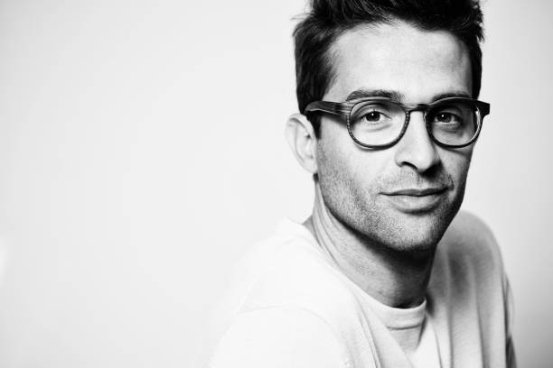 Glasses guy Good looking glasses guy in studio monochrome stock pictures, royalty-free photos & images