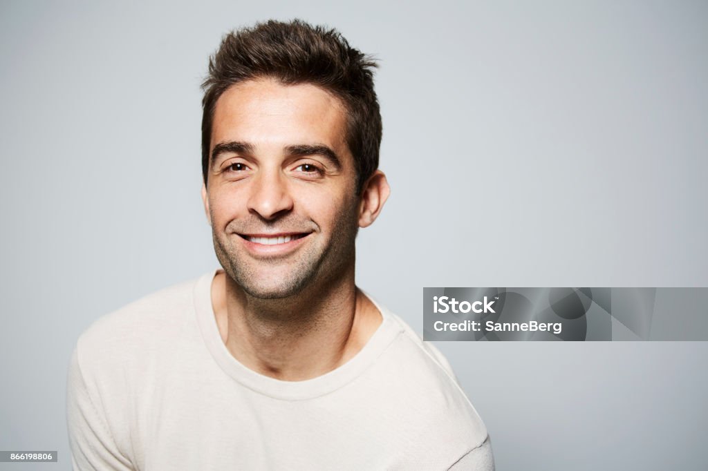 Smiling guy in studio Smiling guy with brown eyes in studio Smiling Stock Photo