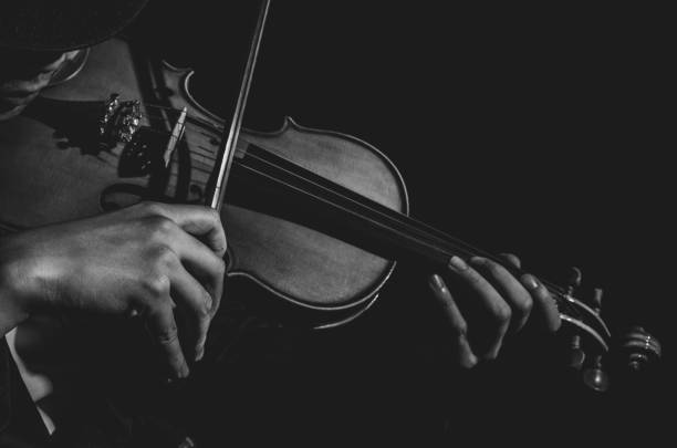 istock Close up Violin player in dark studio, Black and white tone, Musical concept 866199558