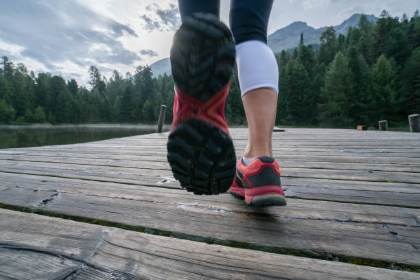 istock Running feet on jetty above lake, Switzerland 866201428