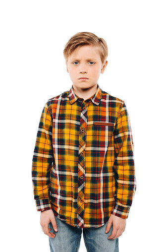 upset little boy looking at camera isolated on white