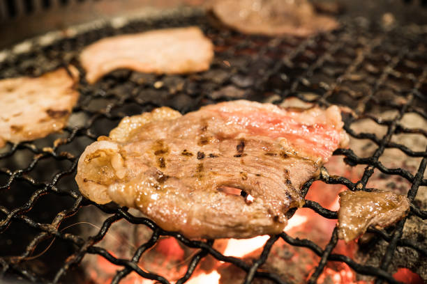 istock Grilled pork on the flaming grill with selective focus point 866203608