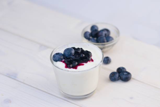 istock Glass cup of yogurt with blueberries 866204374
