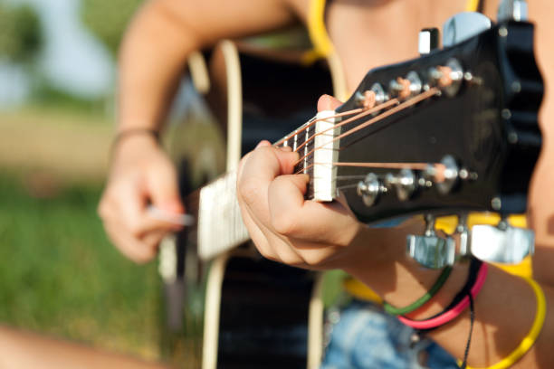 istock Young woman playing acoustic guitar 866209612