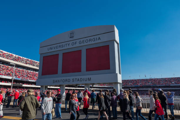 Crowd Passes Under Sanford Stadium Sign Athens, Georgia, United States: November 26, 2017: Crowd passes under Sanford Stadium Sign on Game Day georgia football stock pictures, royalty-free photos & images