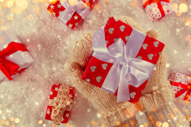 istock Woman hands holding Christmas gift. 866217416